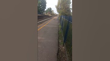 A chiltern railways class 168 train passing king sutton at speed