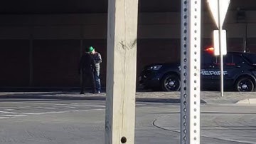 guy urinating and flipping people off on St Patrick