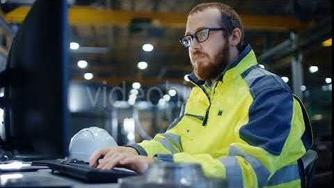 Industrial Engineer Works at Workspace on a Personal Computer.