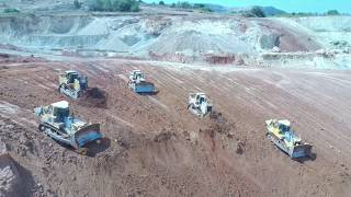 Caterpillar D9T, Caterpillar D9R And Komatsu D275AX Bulldozers Working Side By Side