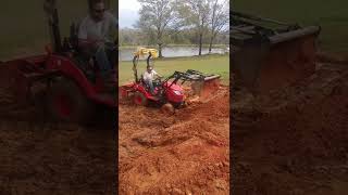 Branson 2205h,with front end loader used for moving dirt.