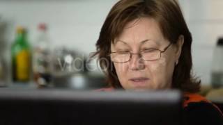 Middle Aged Woman In Glasses Looks At The Screen And Reads - Stock Footage | VideoHive 15484730