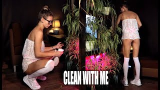 Girl Cleaning The Home Plants