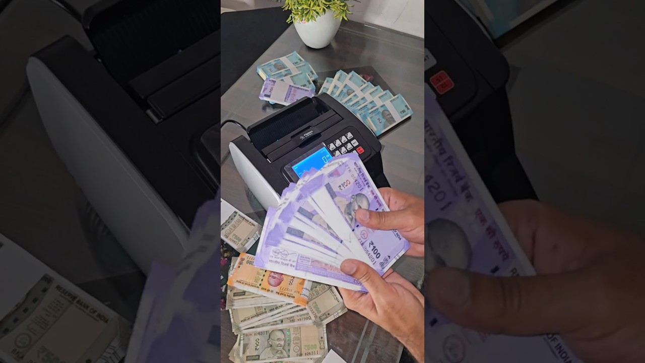 Counting 100-rupees currency notes