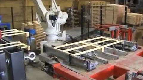 Motoman robots in production cell for bespoke size timber pallets