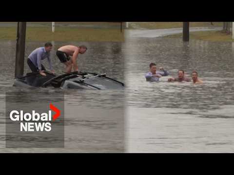 Australian reporter pulls man from sinking car while reporting on floods