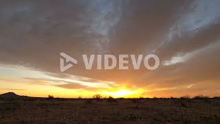 Landscape time lapse of sunrise in Mojave Desert with clouds dissipate
