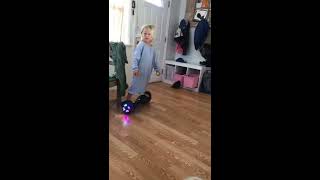 Girl rides hoverboard in house and crashes into kitchen cabinet