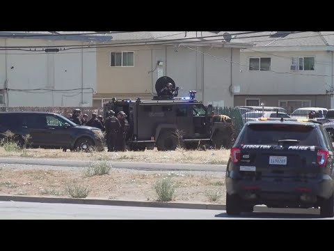 Standoff underway for suspected carjacker accused of shooting a ...