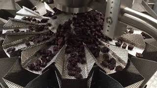 PrimoCombi® multihead weigher dispensing prunes into pre made pouches