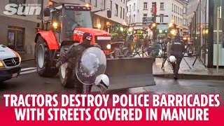 Tractors destroy police barricades with streets covered in manure by protesting farmers