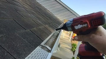 Installing Waterlock gutter protectors on the house.