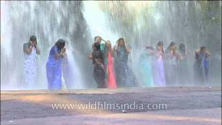 Women In Sarees Shower Under Waterfall At Thirparappu