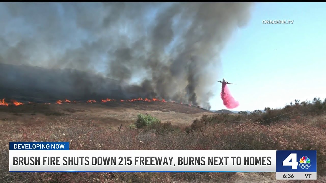 Brush fire shuts down 215 freeway, burns next to homes - YouTube