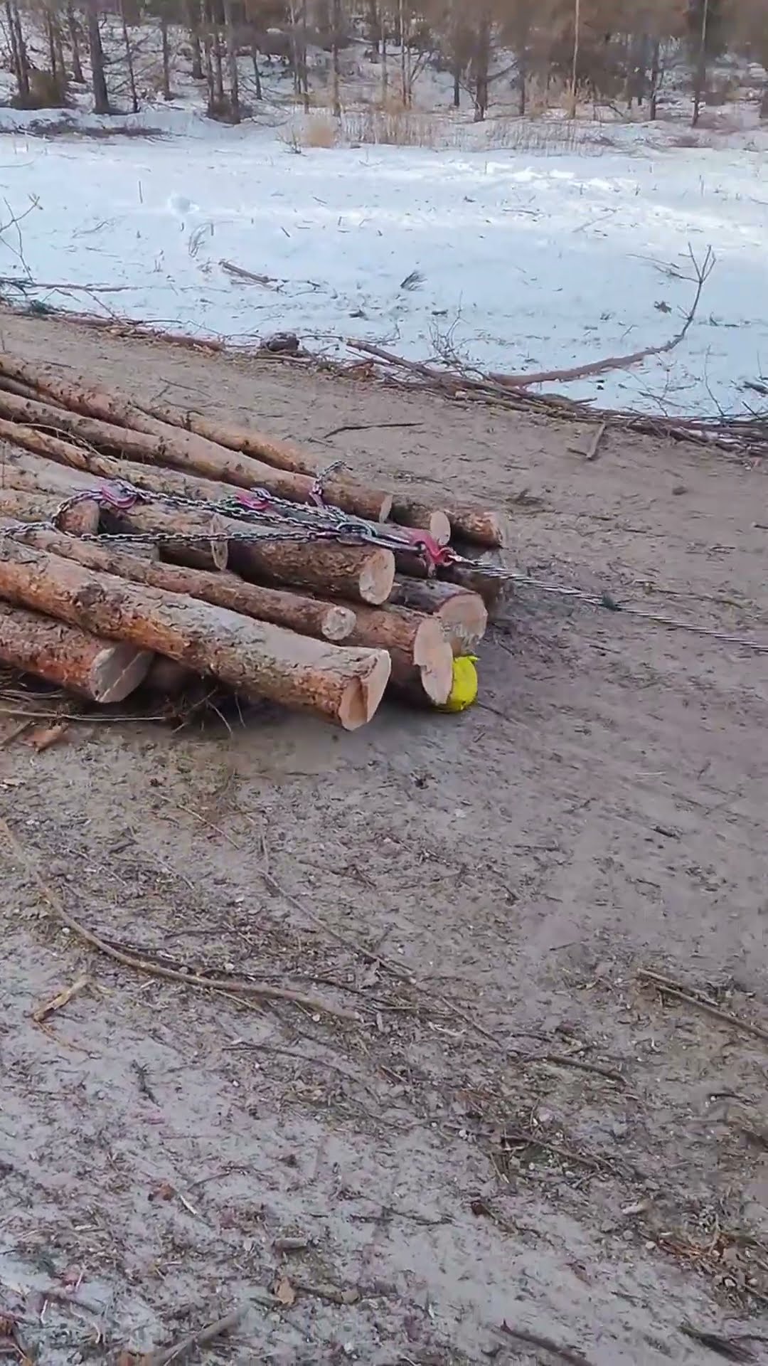 Tractor winches haul lumber- Good tools and machinery make work easy