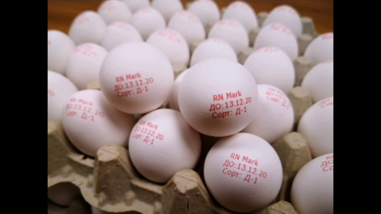 Stamping a tray of eggs 