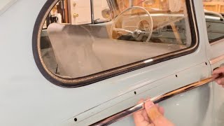 1965 VW bug gets new side molding.