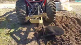 Kubota B26 using a single bottom plow.