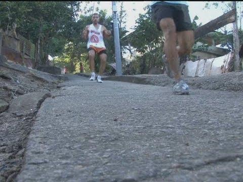 Runners race through Rio de Janeiro's notorious Alemao favela