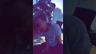 Guy kicks water bottle that's on top of girls head