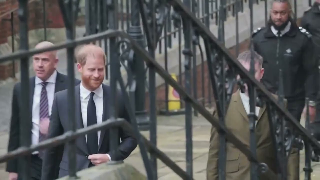 Prince Harry smiles and greets well-wishers outside London’s High Court.