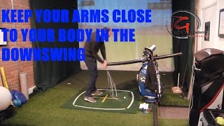 KEEP YOUR ARMS CLOSE TO YOUR BODY IN THE DOWNSWING