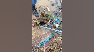 Unclogging Culvert Blocked By Garbage