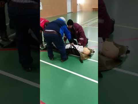 International SOS Staff using lifting 'soft' stretcher