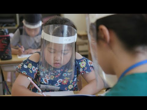 Japanese students go back to school, with face shields | AFP