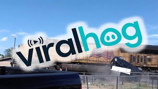 Train Takes out Car Carrier || ViralHog