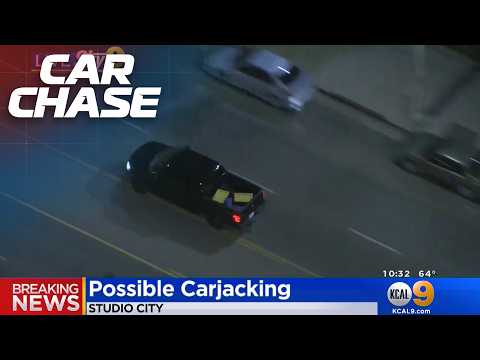 Driver carjacks a pickup truck in the middle of a police pursuit!