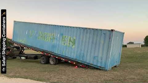 40’ shipping container being unloaded on our 40’ tilt trailer with wench.
