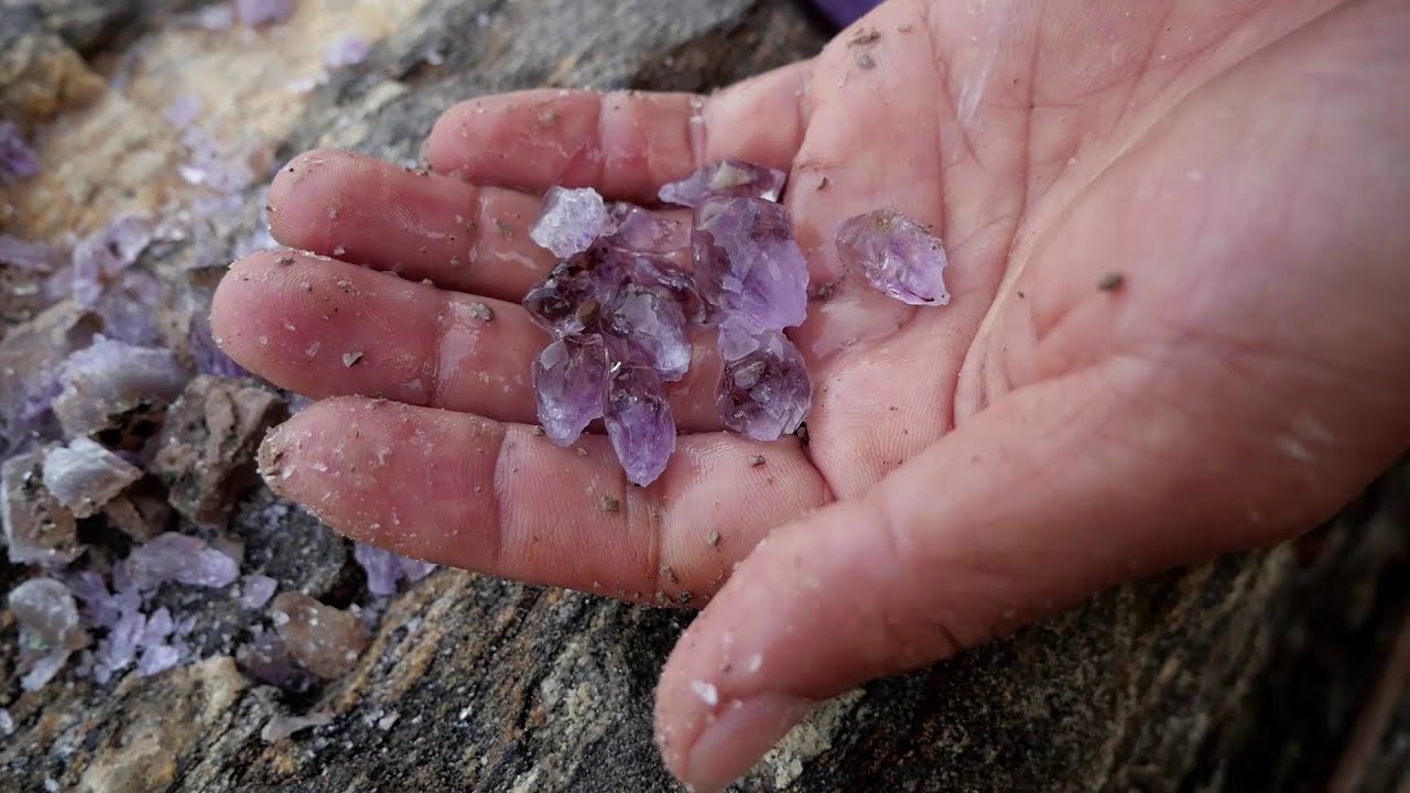 Beautiful green crystals and red crystals in the rocks by the sea. Gems, diamonds