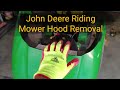 How to remove the hood on a John Deere riding mower most 100 series models.