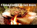 T-bone Steak Cooked on Salt Block over a Camp Fire