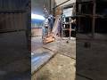 SWINGING AND DROPPING HAMMER IN REPAIRING EXCAVATOR'S END BOSS IN MANUFACTURING WORKSHOP
