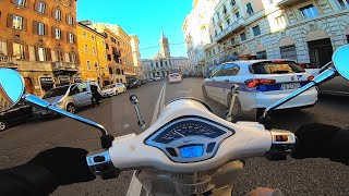 Vespa cruising in Rome, Italy