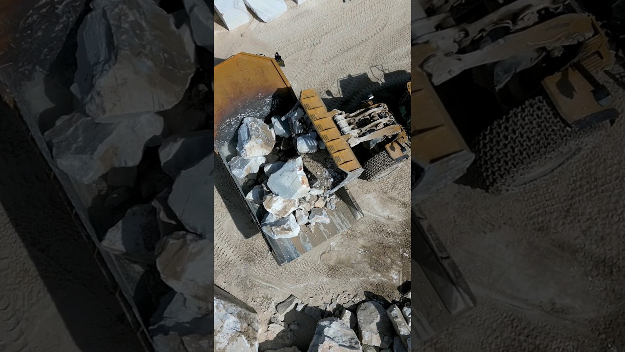 Heavy duty teamwork: CAT 980 Loader and CAT 770 Dump Truck. 