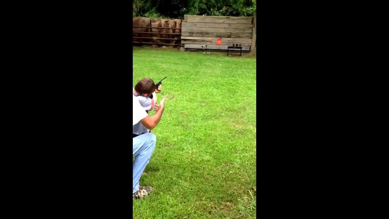 A little kid first time shooting a shot gun