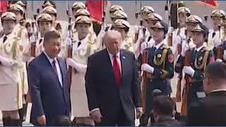 President Trump greeted by Xi and children waving US flags