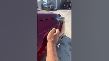 Simple scroll pinstripe design on a Cadillac