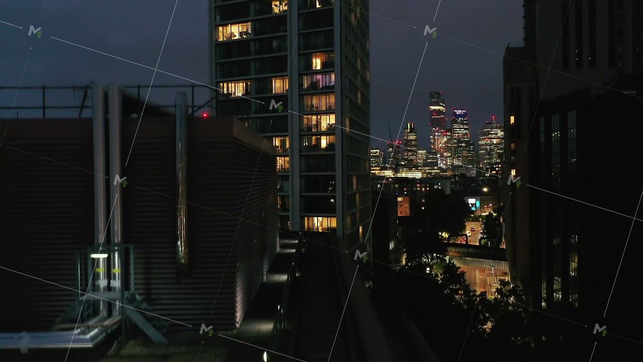 Ascending footage of modern office building. Close up view to lighten windows, offices at night
