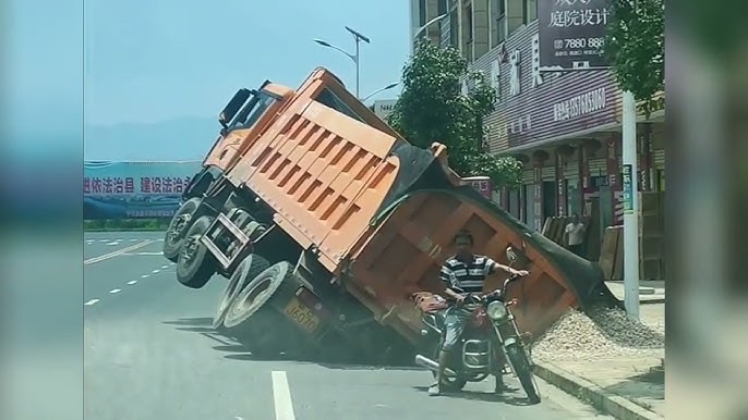 Video of overloaded truck teetering past pedestrians with inches to spare  in China