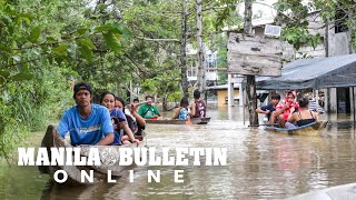 Despite chest-deep flooding, Residents continue their daily activities using bangkas