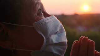Praying at Sunset: Old Woman in Protective Mask Gives Powerful deed