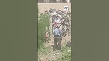 Man crawls under barbed fence at US-Mexico border