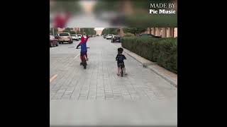 Spider Kid And Iron Kid Riding A Cycle