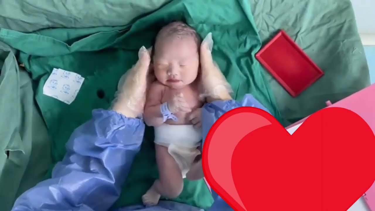 First time dress up beautiful newborn baby just after birth
