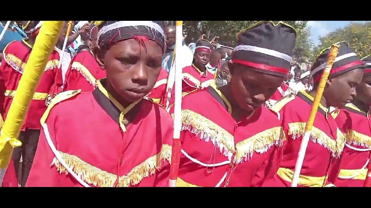 Amazing pmc children lead Bishop Simon Peter Kamomoe in ground in closing the year of jubilee .