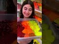 mixing all my hot color glitters together in clear slime